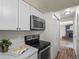 Bright kitchen featuring stainless steel appliances, white cabinets and countertops at 10415 Owens Cir, Broomfield, CO 80021