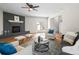 Comfortable living room with a fireplace, hardwood floors, a ceiling fan, and neutral paint at 10415 Owens Cir, Broomfield, CO 80021