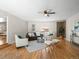 Bright living room with hardwood floors, a ceiling fan, neutral paint, and comfortable seating at 10415 Owens Cir, Broomfield, CO 80021