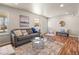 Bright living room features hardwood floors, natural light, and stylish modern furnishings at 10415 Owens Cir, Broomfield, CO 80021