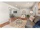 Comfortable living space featuring wood floors and a seamless transition to the dining area at 10415 Owens Cir, Broomfield, CO 80021