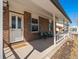 Inviting front porch featuring comfortable seating and decorative accents by the home's entrance at 10415 Owens Cir, Broomfield, CO 80021