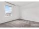 Bright bedroom with grey carpet and large window at 5087 Lake Port Ave, Firestone, CO 80504