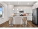 Kitchen island with seating, stainless steel appliances and white cabinets at 5087 Lake Port Ave, Firestone, CO 80504