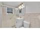 Neutral bathroom with window and updated vanity at 4940 Adams St, Denver, CO 80216