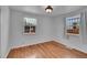 Cozy bedroom with hardwood floors, neutral paint and two windows offering ample natural light at 4940 Adams St, Denver, CO 80216