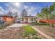 Charming single-story home featuring a well-maintained front yard and a cozy covered entry at 4940 Adams St, Denver, CO 80216