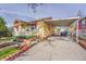 Charming single-Gathering home with a covered parking and well-maintained front yard with flowerbeds at 4940 Adams St, Denver, CO 80216