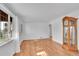 Bright living room featuring hardwood floors, fresh paint, and a view into other rooms at 4940 Adams St, Denver, CO 80216