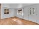Bright living room featuring hardwood floors, fresh paint, and natural light through two large windows at 4940 Adams St, Denver, CO 80216