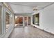 Enclosed sunroom with floor-to-ceiling windows, offering abundant light and seamless indoor/outdoor living at 4940 Adams St, Denver, CO 80216