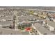 Aerial view of a residential community with a nearby lake and a townhome with private balconies at 11250 Florence St # 21A, Commerce City, CO 80640