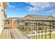 Open balcony with a railing and expansive view of the neighborhood and blue sky at 11250 Florence St # 21A, Commerce City, CO 80640