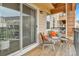 Inviting outdoor balcony featuring wicker chairs with bright pillows, and a patio table at 11250 Florence St # 21A, Commerce City, CO 80640