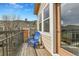 Relaxing balcony featuring a blue chair and small table with scenic views at 11250 Florence St # 21A, Commerce City, CO 80640