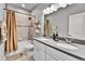 Bright bathroom featuring a double vanity, large mirror, bathtub with shower, and decorative shelves at 11250 Florence St # 21A, Commerce City, CO 80640