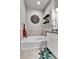 Cozy bathroom featuring a soaking tub, tiled walls, and decorative wall art at 11250 Florence St # 21A, Commerce City, CO 80640