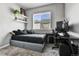 Modern bedroom with a large window, decorative shelves, and an office space at 11250 Florence St # 21A, Commerce City, CO 80640
