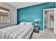 Bedroom featuring a double bed, modern colors and an in-unit laundry room at 11250 Florence St # 21A, Commerce City, CO 80640