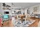 Bright dining area featuring a wooden table with seating for six, a modern rug, and an open layout into the kitchen at 11250 Florence St # 21A, Commerce City, CO 80640