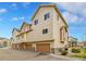 Attractive townhouse exterior with garages, neutral siding, and well-maintained landscaping at 11250 Florence St # 21A, Commerce City, CO 80640