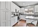 Updated kitchen with stainless steel appliances, white cabinets, and views to the neighborhood at 11250 Florence St # 21A, Commerce City, CO 80640