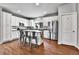 Bright, open kitchen with island seating, stainless steel appliances, and wood flooring at 11250 Florence St # 21A, Commerce City, CO 80640