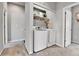 Convenient laundry room setup with a washer, dryer, storage shelf, and adjacent doorway at 11250 Florence St # 21A, Commerce City, CO 80640