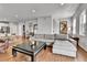 Spacious living room with hardwood floors, a sectional sofa, and a view of the open floor plan at 11250 Florence St # 21A, Commerce City, CO 80640