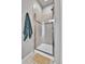 Modern shower with glass door, tiled walls, and a decorative accent stripe at 11250 Florence St # 21A, Commerce City, CO 80640