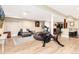 Finished basement features a workout area, a seating area, and a kitchenette with bar seating at 2480 W Jamison Way, Littleton, CO 80120