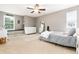 Comfortable bedroom with neutral tones, natural light, a full length mirror, and comfortable decor at 2480 W Jamison Way, Littleton, CO 80120