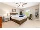 Inviting bedroom with a ceiling fan, ample natural light, wooden accents, and comfortable decor at 2480 W Jamison Way, Littleton, CO 80120