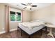 Bedroom featuring a neutral color palette, a ceiling fan, a window, and tan carpeting at 2480 W Jamison Way, Littleton, CO 80120