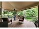 Spacious covered deck with comfortable seating and views of the surrounding landscape at 2480 W Jamison Way, Littleton, CO 80120