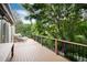 Large deck overlooking lush greenery and boasting lounge chairs at 2480 W Jamison Way, Littleton, CO 80120