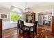 Elegant dining room featuring wood floors, large window, and a modern chandelier at 2480 W Jamison Way, Littleton, CO 80120