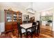Elegant dining room featuring wood floors, china cabinet, and view to the kitchen at 2480 W Jamison Way, Littleton, CO 80120