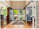 Elegant foyer featuring hardwood floors, barn door, and a view of the landscaped front yard at 2480 W Jamison Way, Littleton, CO 80120