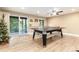 Bright game room featuring a ping pong table, a ceiling fan, and a sliding glass door to the outside at 2480 W Jamison Way, Littleton, CO 80120