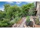 Charming garden featuring raised garden beds, stepping stones, and lush foliage, creating an inviting outdoor space at 2480 W Jamison Way, Littleton, CO 80120