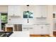 Bright kitchen with white cabinets, modern countertops and stainless steel appliances at 2480 W Jamison Way, Littleton, CO 80120