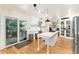 Open kitchen with white cabinets, center island, and access to outdoor deck at 2480 W Jamison Way, Littleton, CO 80120