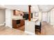 Basement kitchenette features granite countertops, wood cabinets, a microwave, and seating for three at 2480 W Jamison Way, Littleton, CO 80120