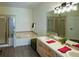 Bathroom featuring dual sinks, a soaking tub, a walk-in shower, and modern finishes at 13708 Legend Trl # 101, Broomfield, CO 80023