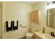 Cozy bathroom features a wooden cabinet, toilet, and vanity with decorative plant at 13708 Legend Trl # 101, Broomfield, CO 80023
