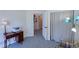 Bedroom with a desk, lamp, and a window for ample natural light at 13708 Legend Trl # 101, Broomfield, CO 80023