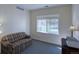 Relaxing bedroom with a cozy couch and a large window offering natural light at 13708 Legend Trl # 101, Broomfield, CO 80023
