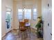 Breakfast nook featuring a bay window and tile flooring, with a door to the patio at 13708 Legend Trl # 101, Broomfield, CO 80023