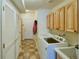 Laundry room with front-load washer, overhead cabinets, and access to the exterior at 13708 Legend Trl # 101, Broomfield, CO 80023